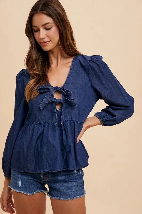 Navy denim tie-front peplum long-sleeve top with bow at neckline