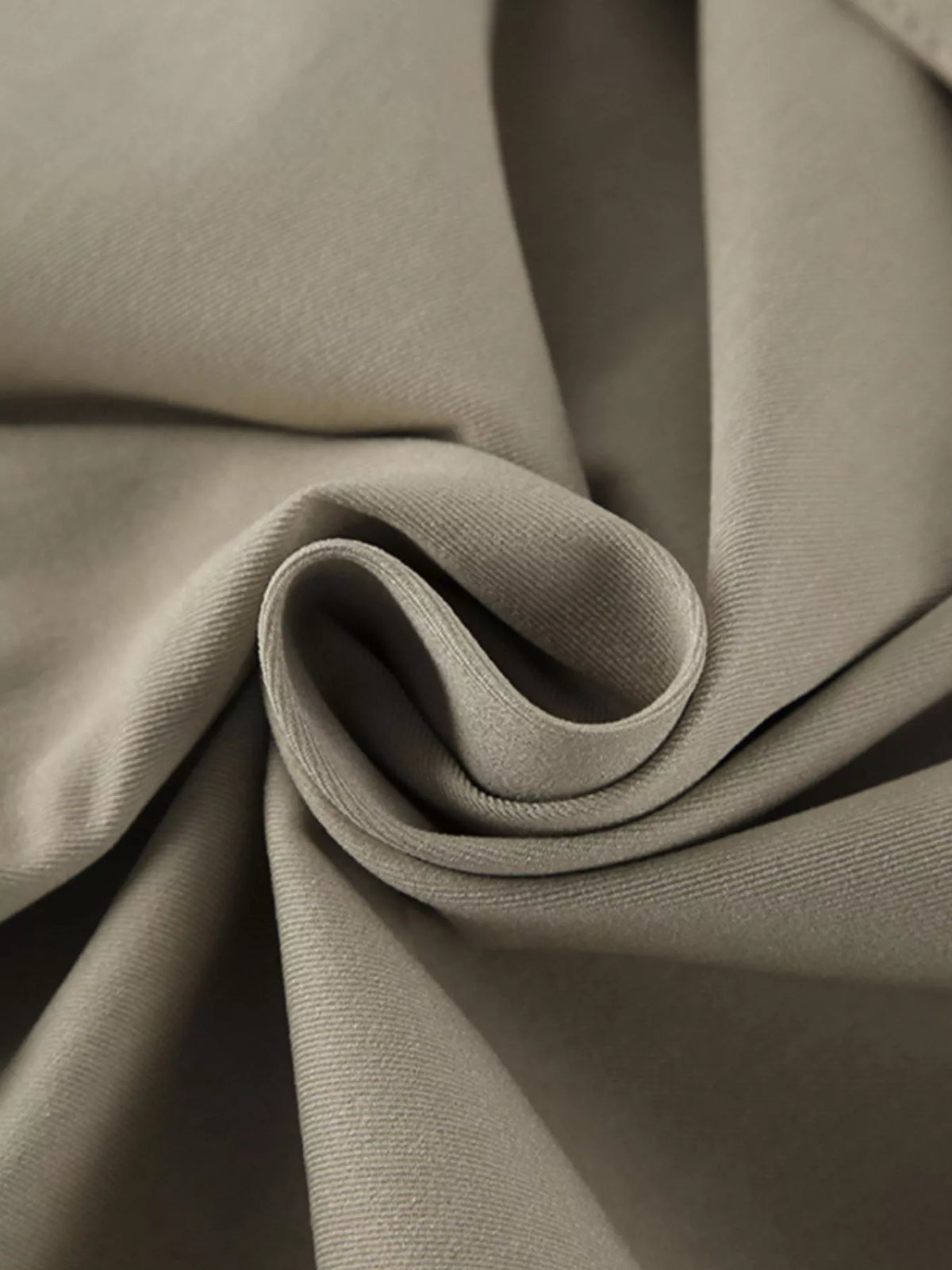 Khaki trench coat fabric close-up with smooth woven texture and soft drape