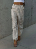 Beige drawstring pants with pockets and ankle cuffs