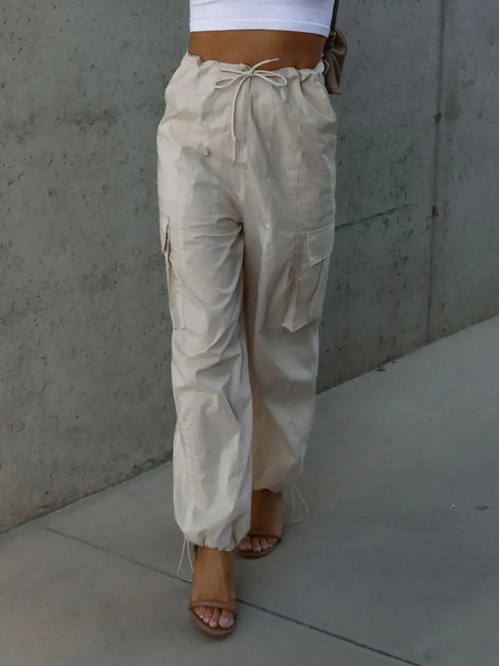 Beige drawstring pants with pockets and ankle cuffs