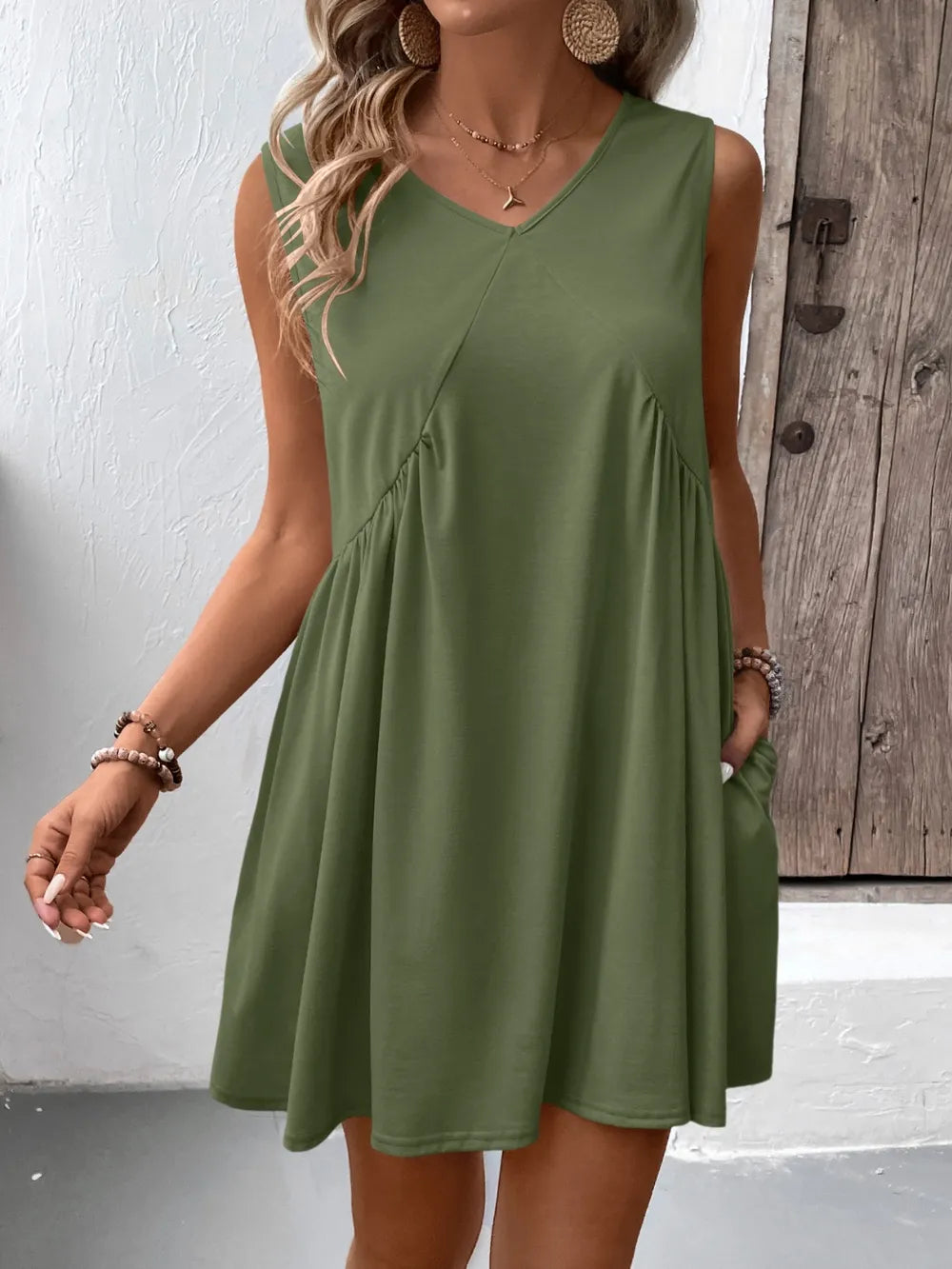 Ivy Lane Ruched V-Neck Sleeveless Mini Dress in olive-green with a flowing A-line silhouette.