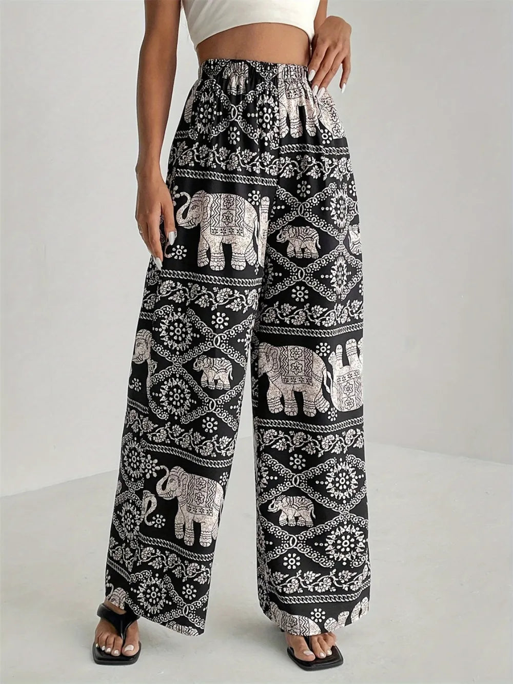 Black printed wide-leg pants with elephant border print and elastic waist