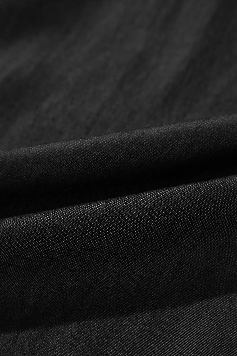 Black textured woven fabric with soft drape
