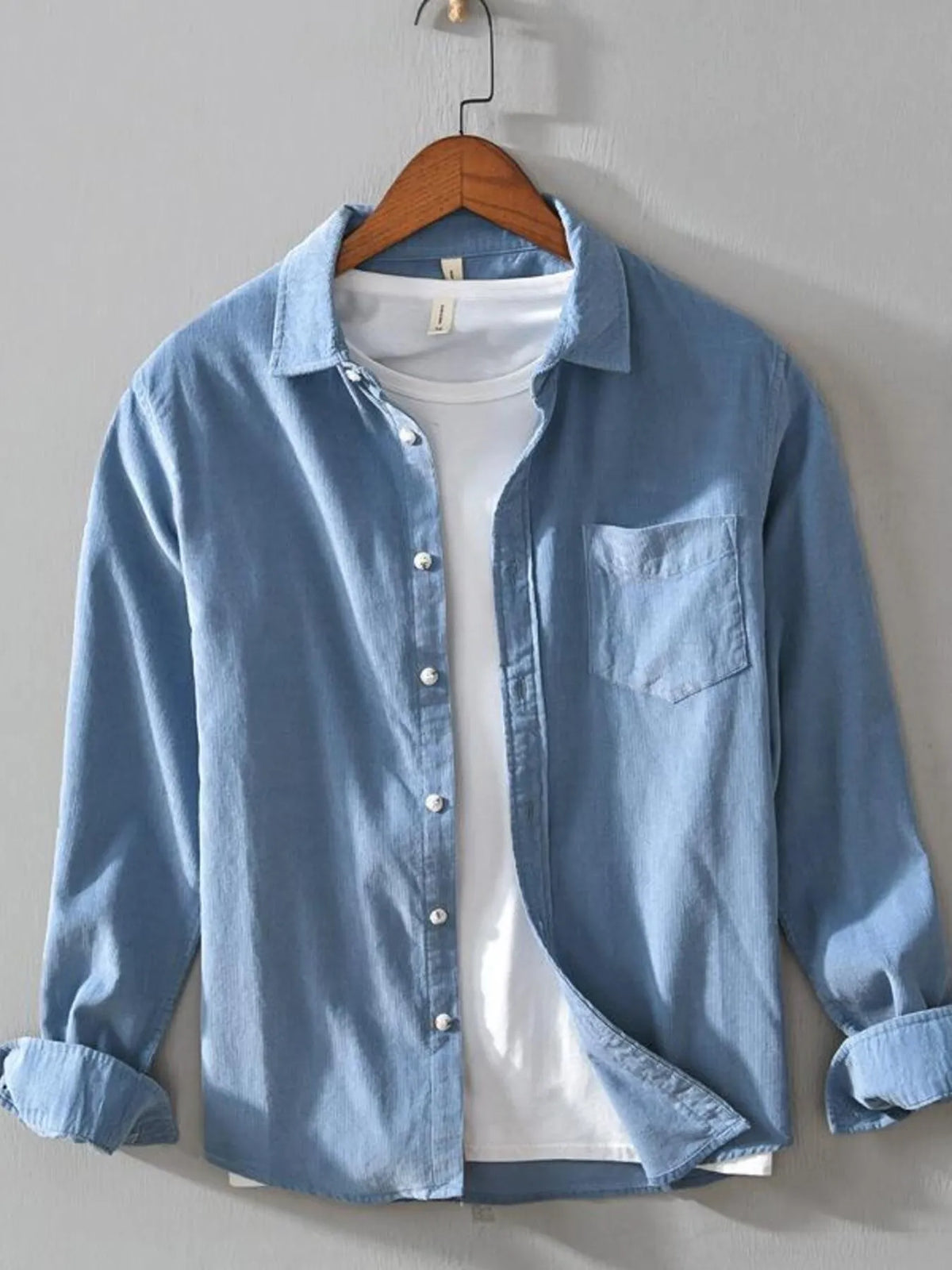 Men's light blue cotton button-up shirt with long sleeves and chest pocket
