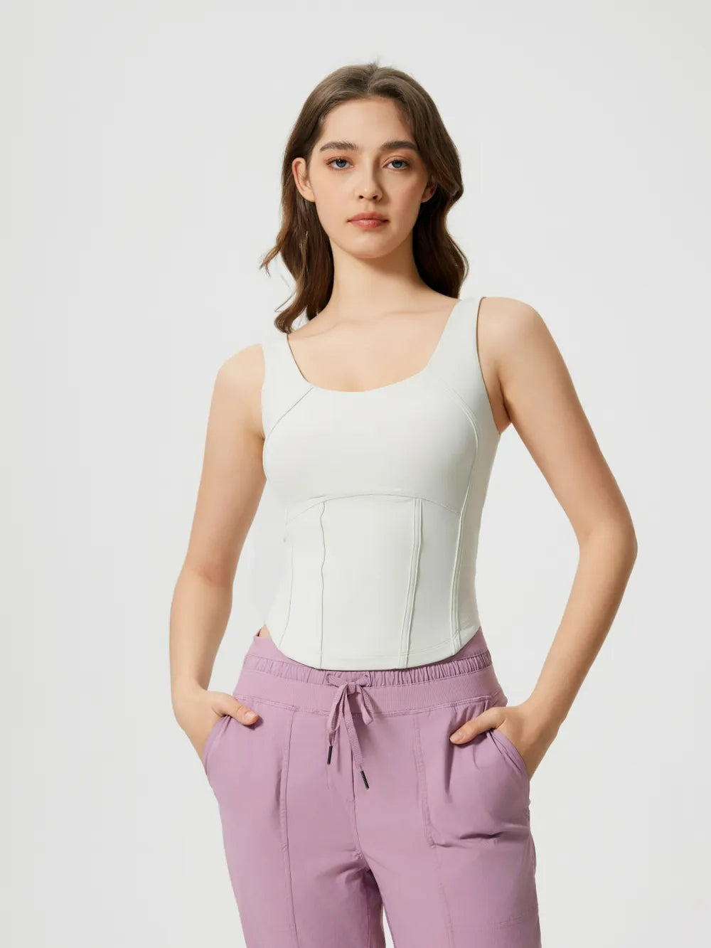 White round-neck active tank with wide straps and fitted corset-style seams