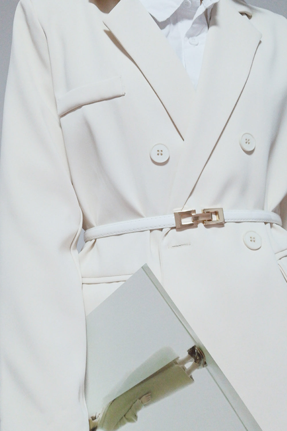 White skinny belt with gold-tone square buckle, styled at the waist
