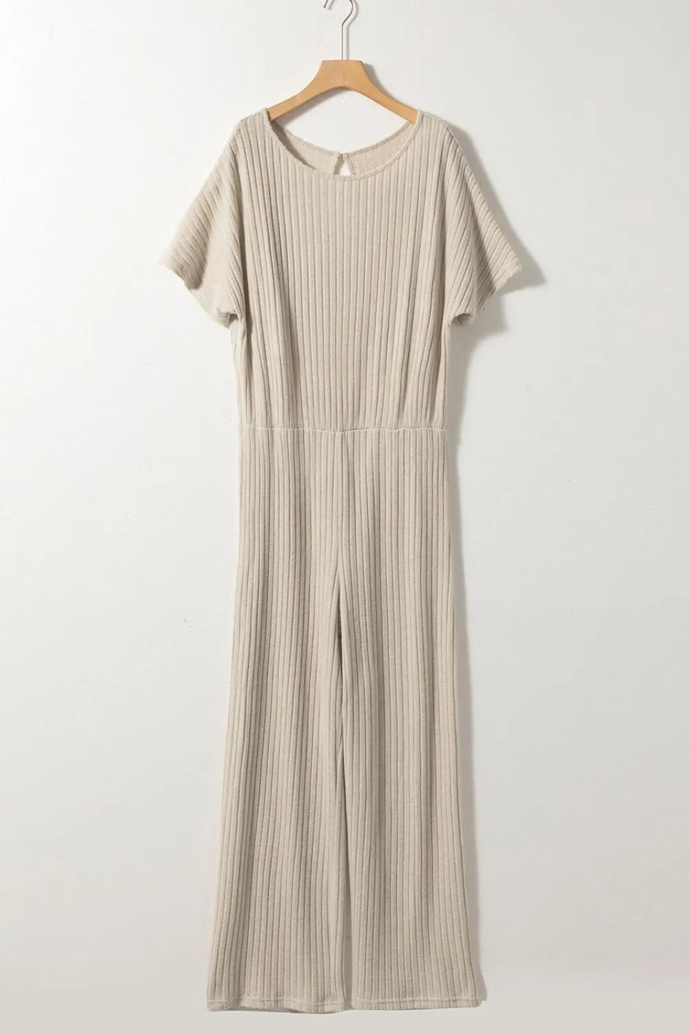 Beige ribbed knit wide-leg jumpsuit on hanger with short sleeves and keyhole