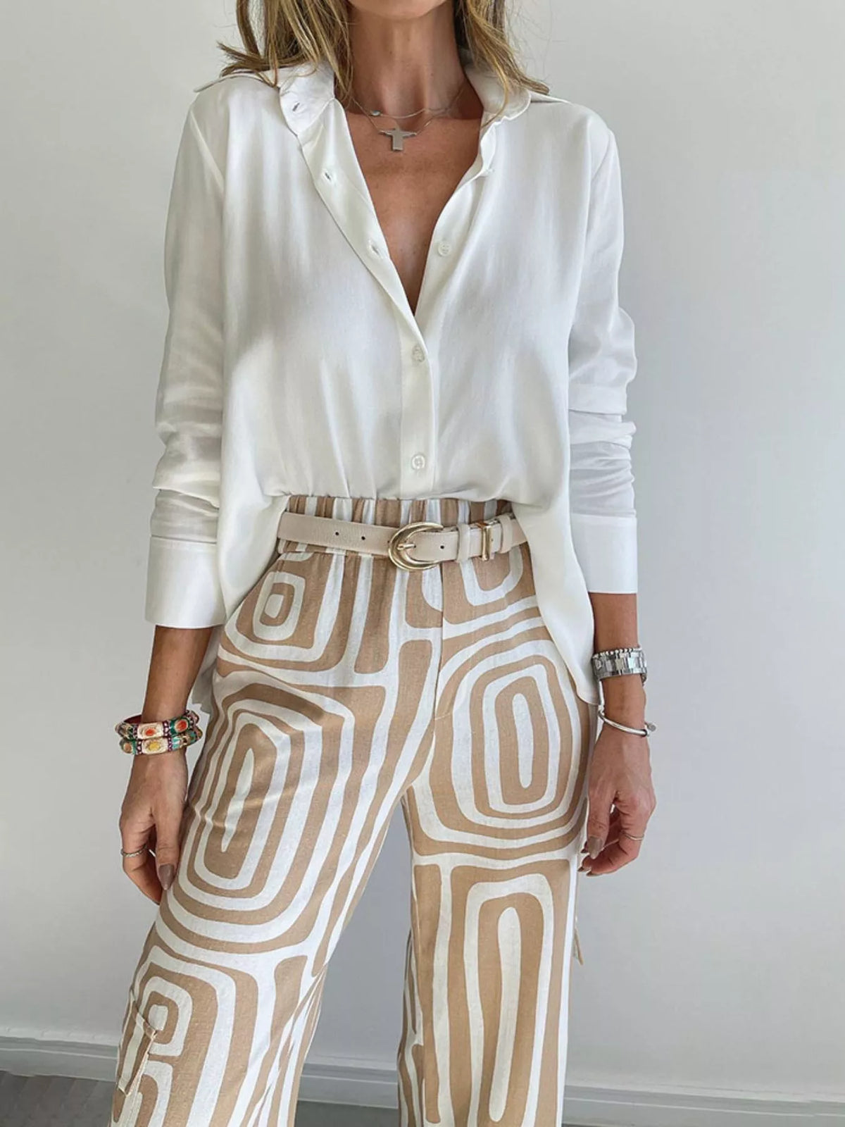 Button-down shirt and geometric pants set with cream fabric and tan square pattern.