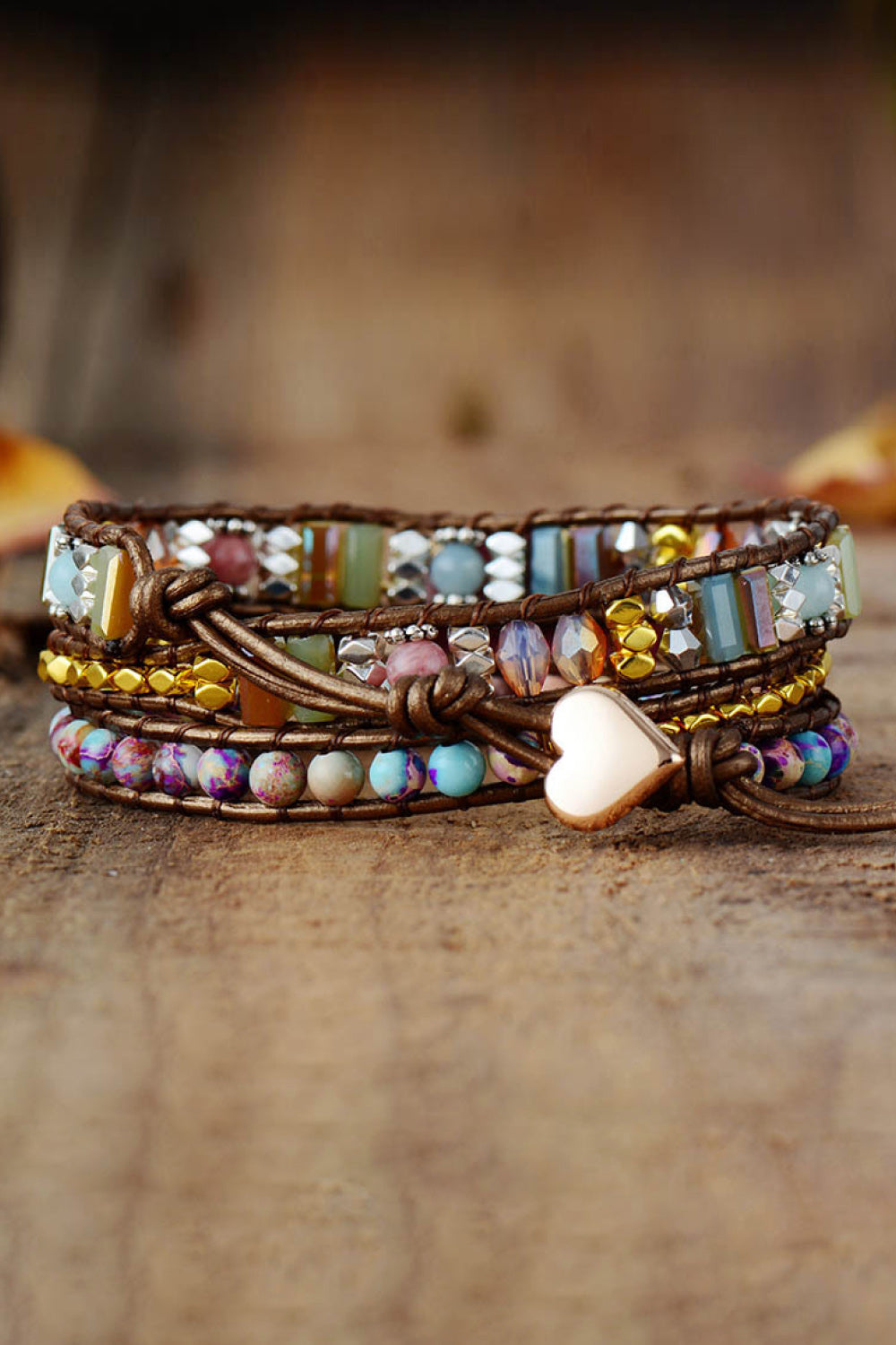 Beaded wrap bracelet with oval pink center, multicolor beads, and white heart charm