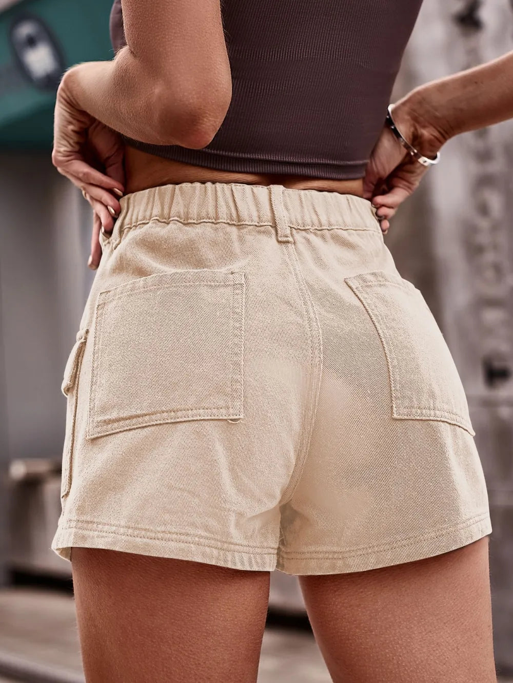 High-waist tan denim shorts with two back patch pockets and front button