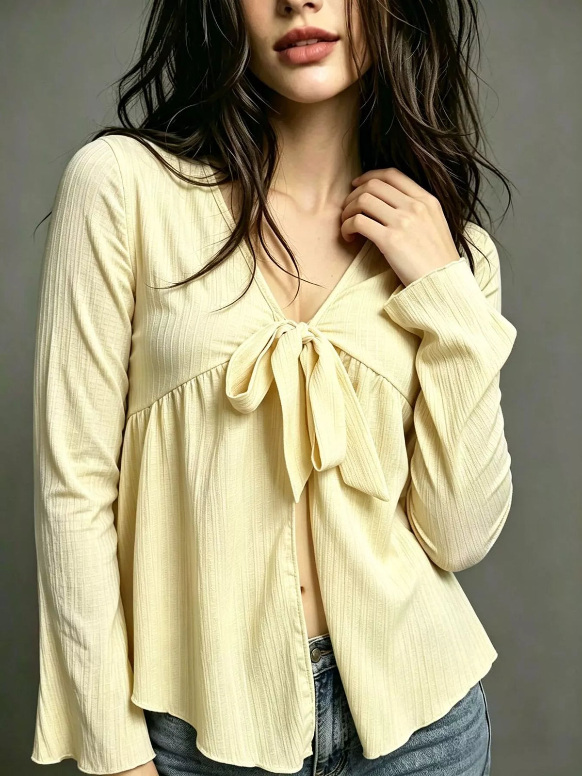 Light yellow tie-front babydoll blouse with V-neck bow and long flared sleeves