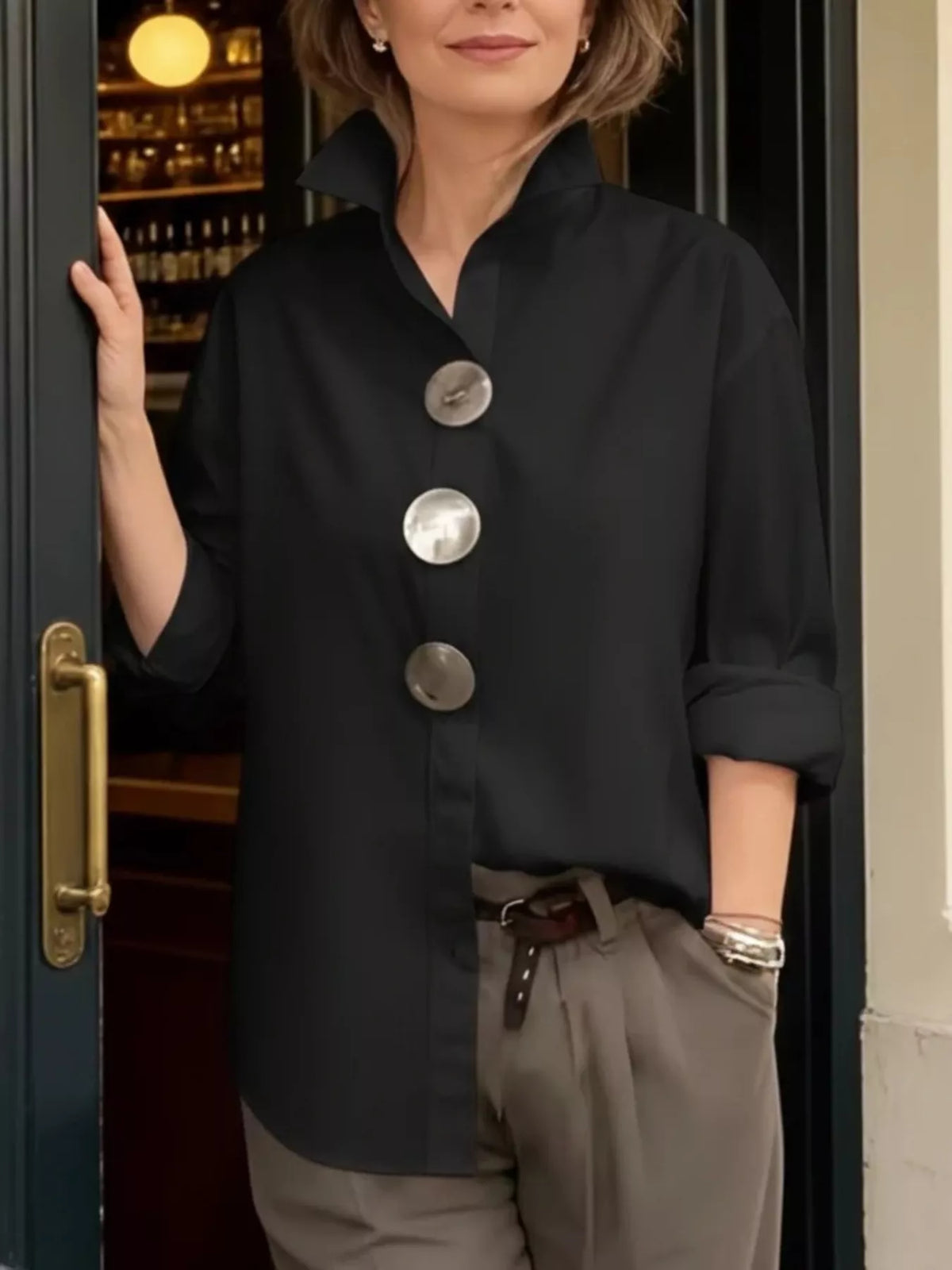 Black oversized long-sleeve button shirt with metallic round buttons and point collar