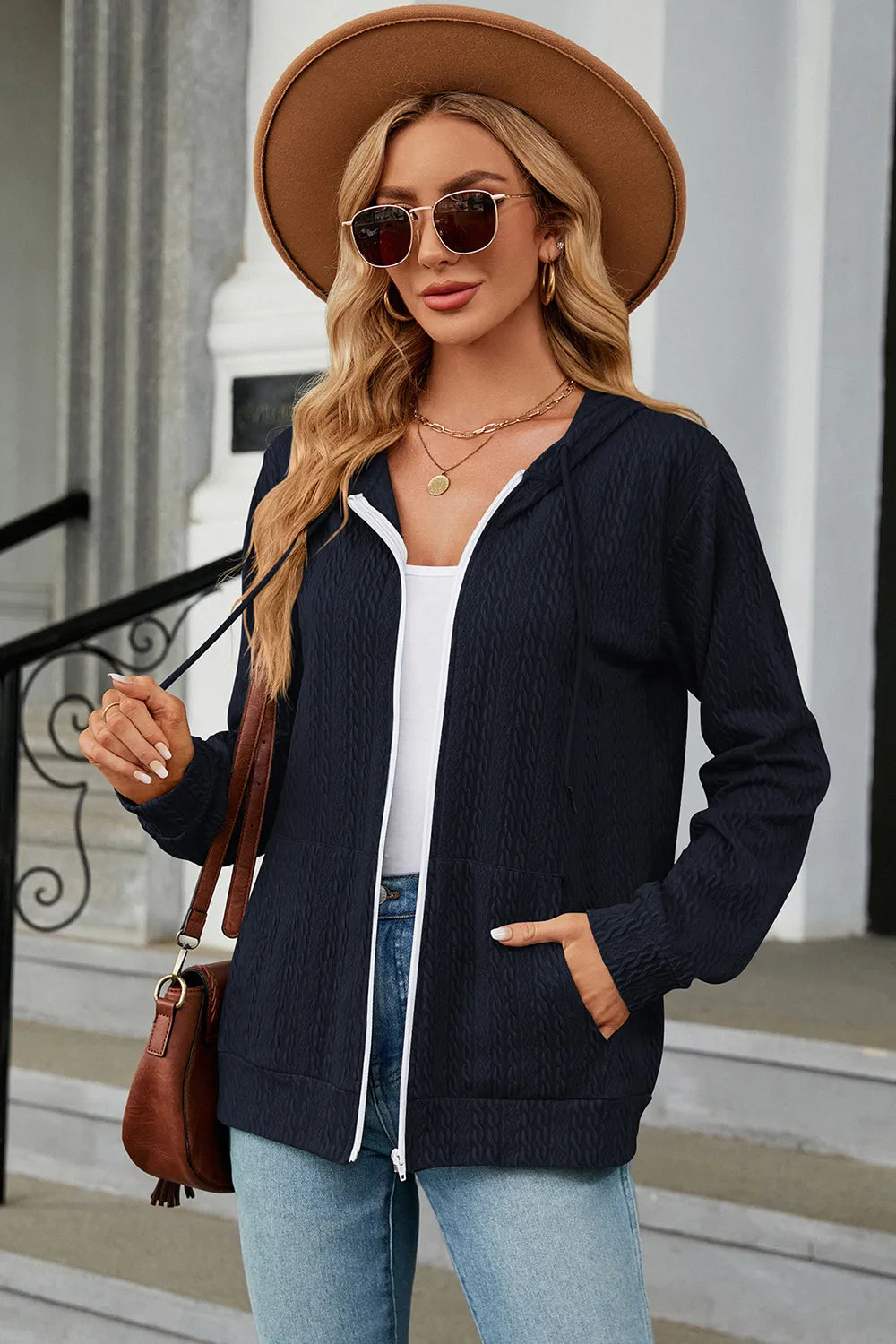 Dark blue drawstring zip-up hoodie with hood, white-trim zipper, and front kangaroo pocket