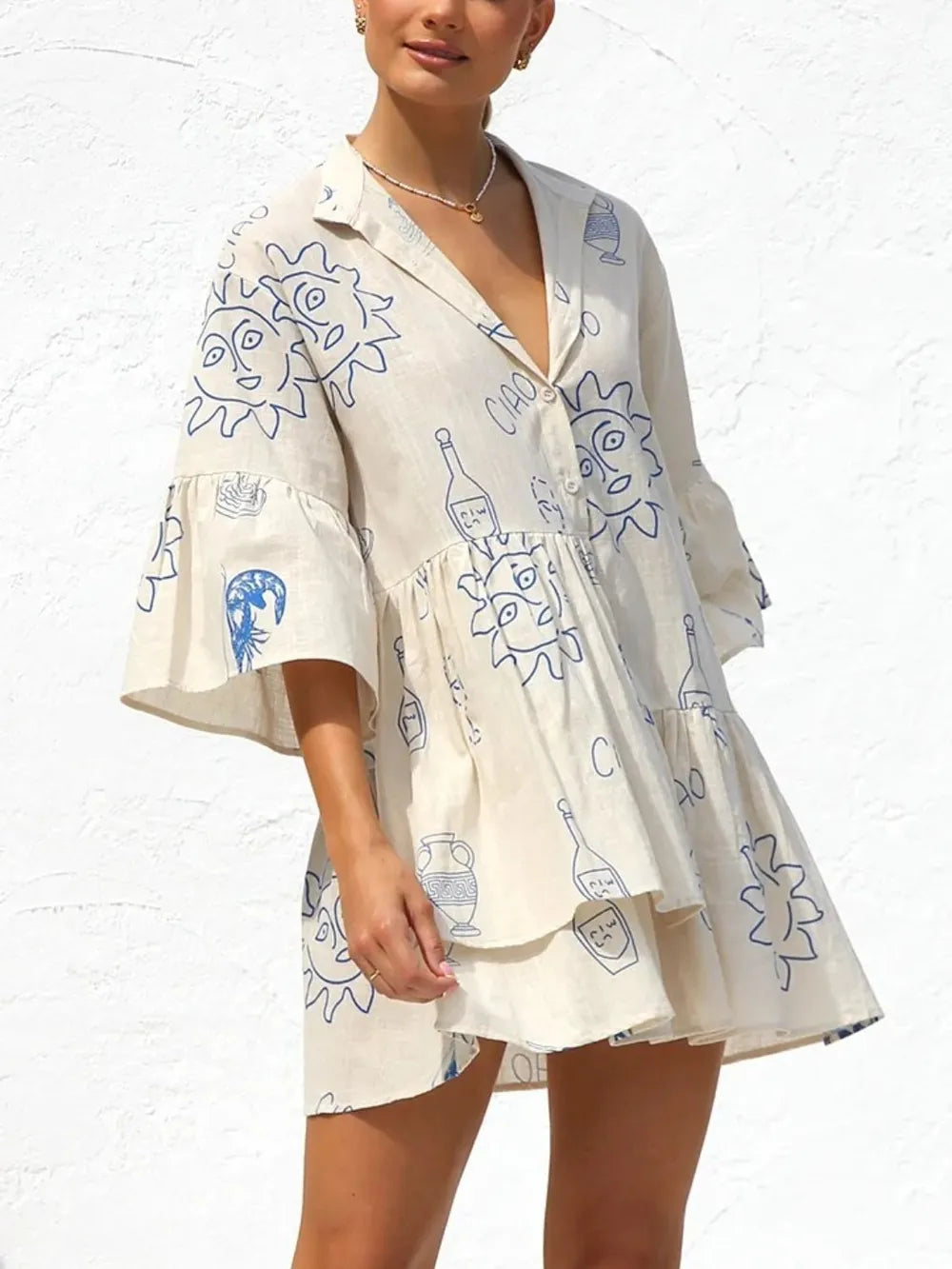Cream button-front printed mini dress with blue doodle graphics and ruffled sleeves
