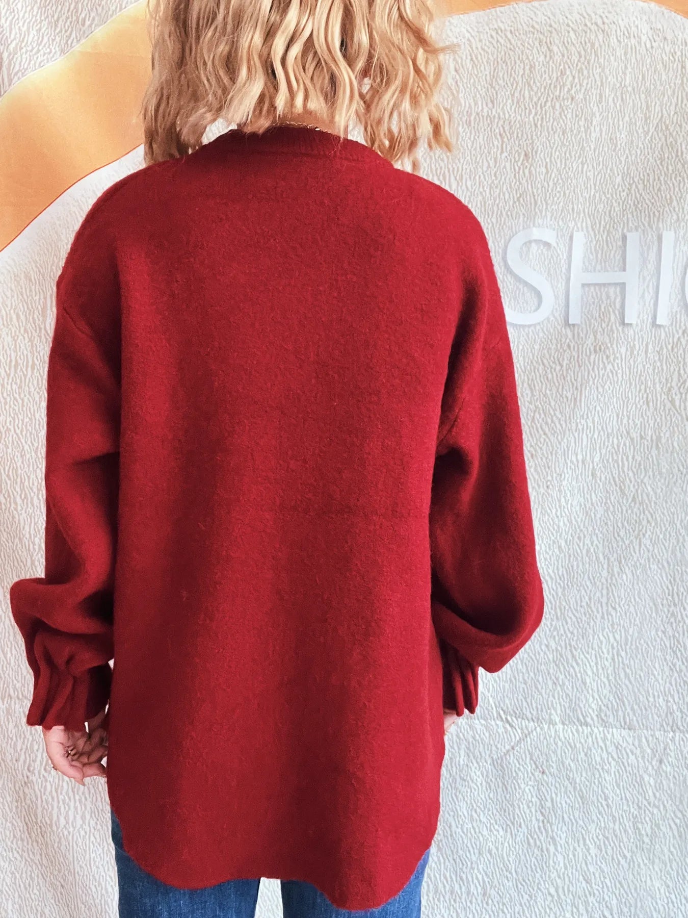 Red round neck dropped-shoulder sweater, back view with ribbed cuffs