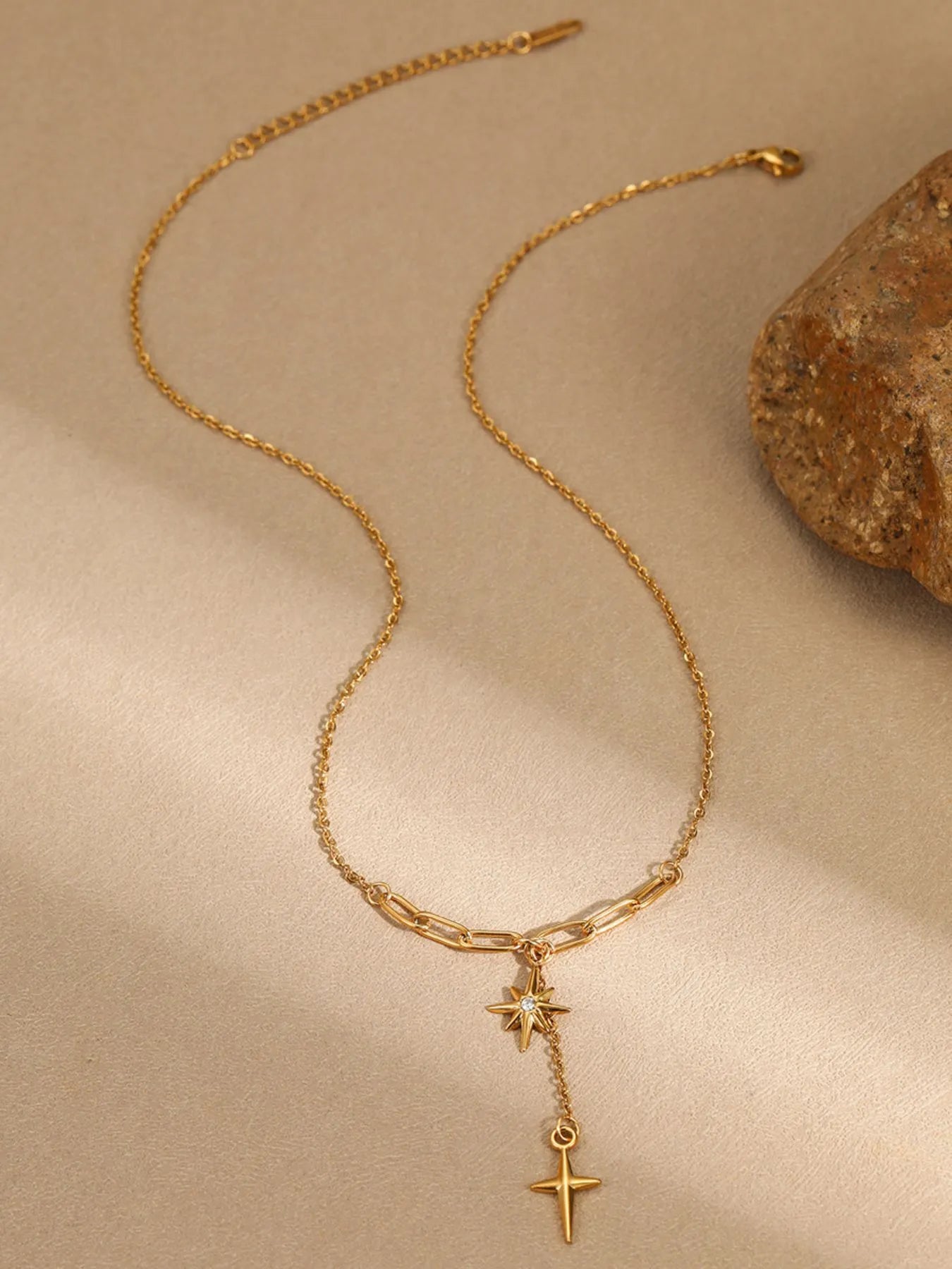 Gold-plated pendant necklace with star and cross charms and a link chain