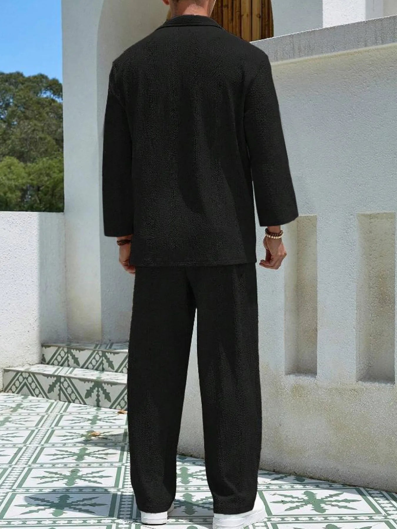 Men's long-sleeve top and pants set in black, back view with long sleeves and cuffed hems
