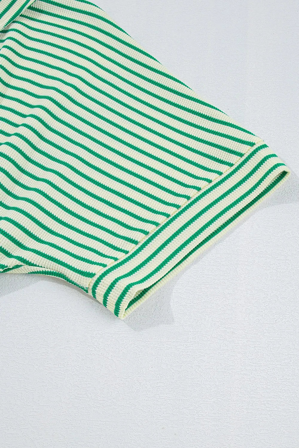 Green-and-white striped half-sleeve romper cuff with ribbed trim