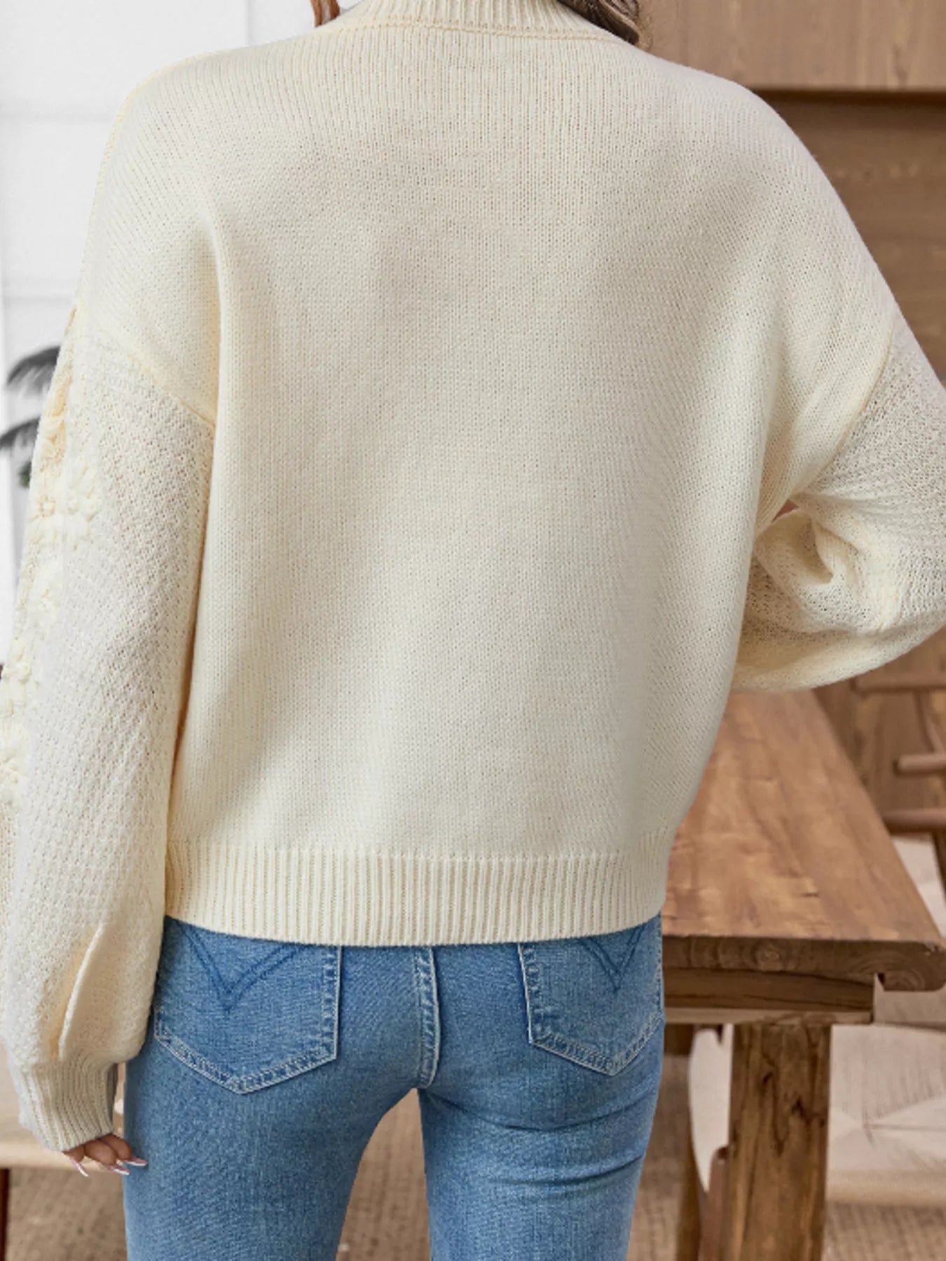 Cream floral knit sweater back view with long sleeves and ribbed hem