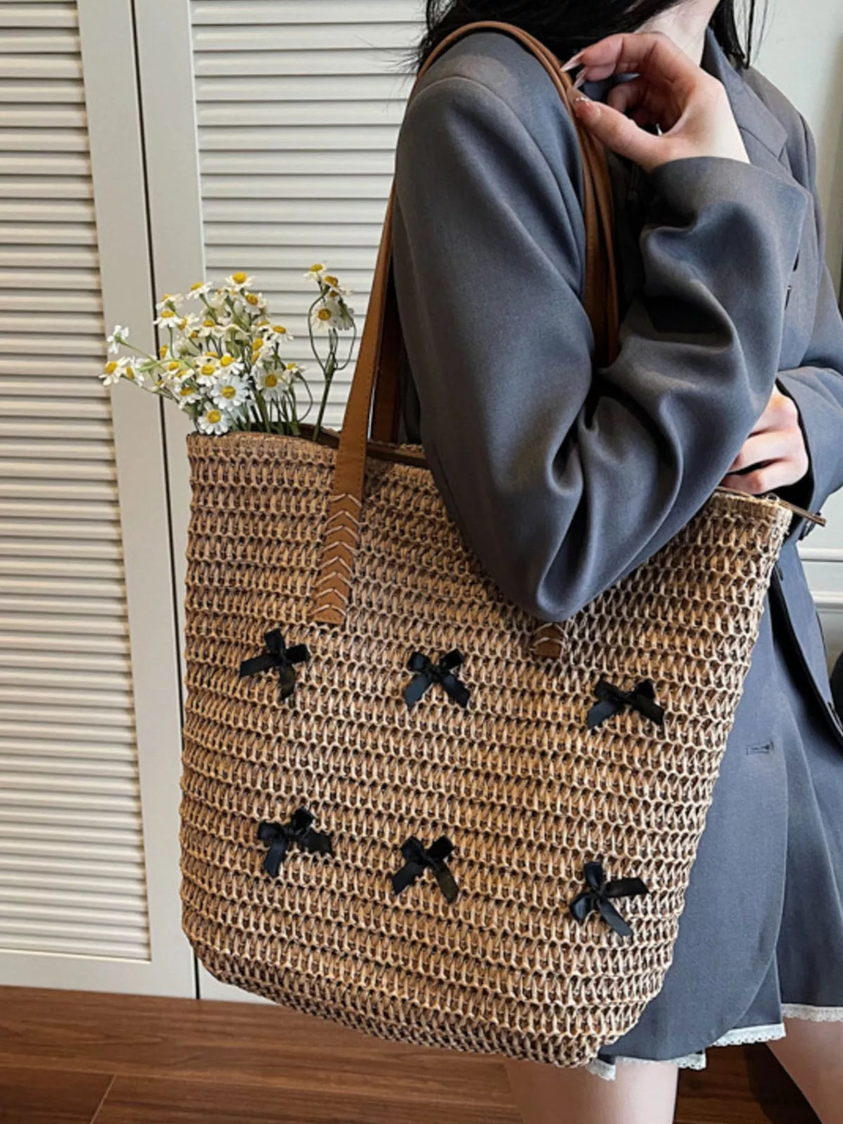 Caramel woven straw tote bag with bow applique design and long shoulder straps
