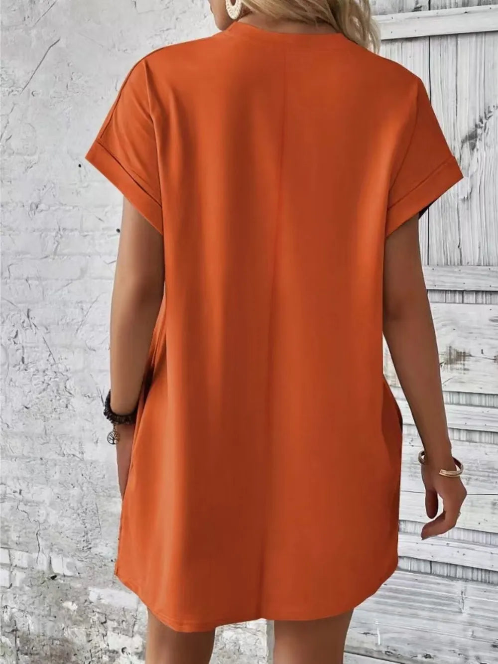 Orange short-sleeve round-neck tunic dress with loose fit and curved hem