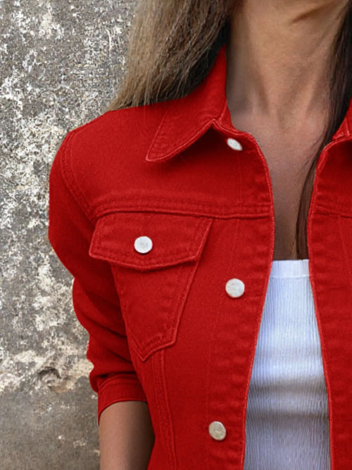 Red button front denim jacket close-up with chest flap pocket and metal buttons