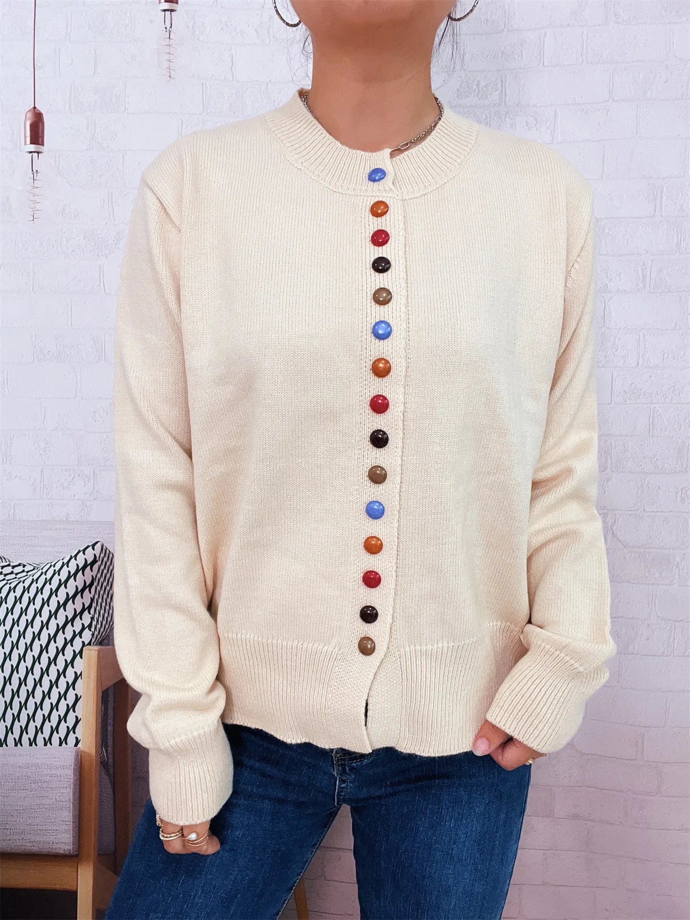 Cream button-front cardigan with ribbed cuffs and vertical multicolor buttons