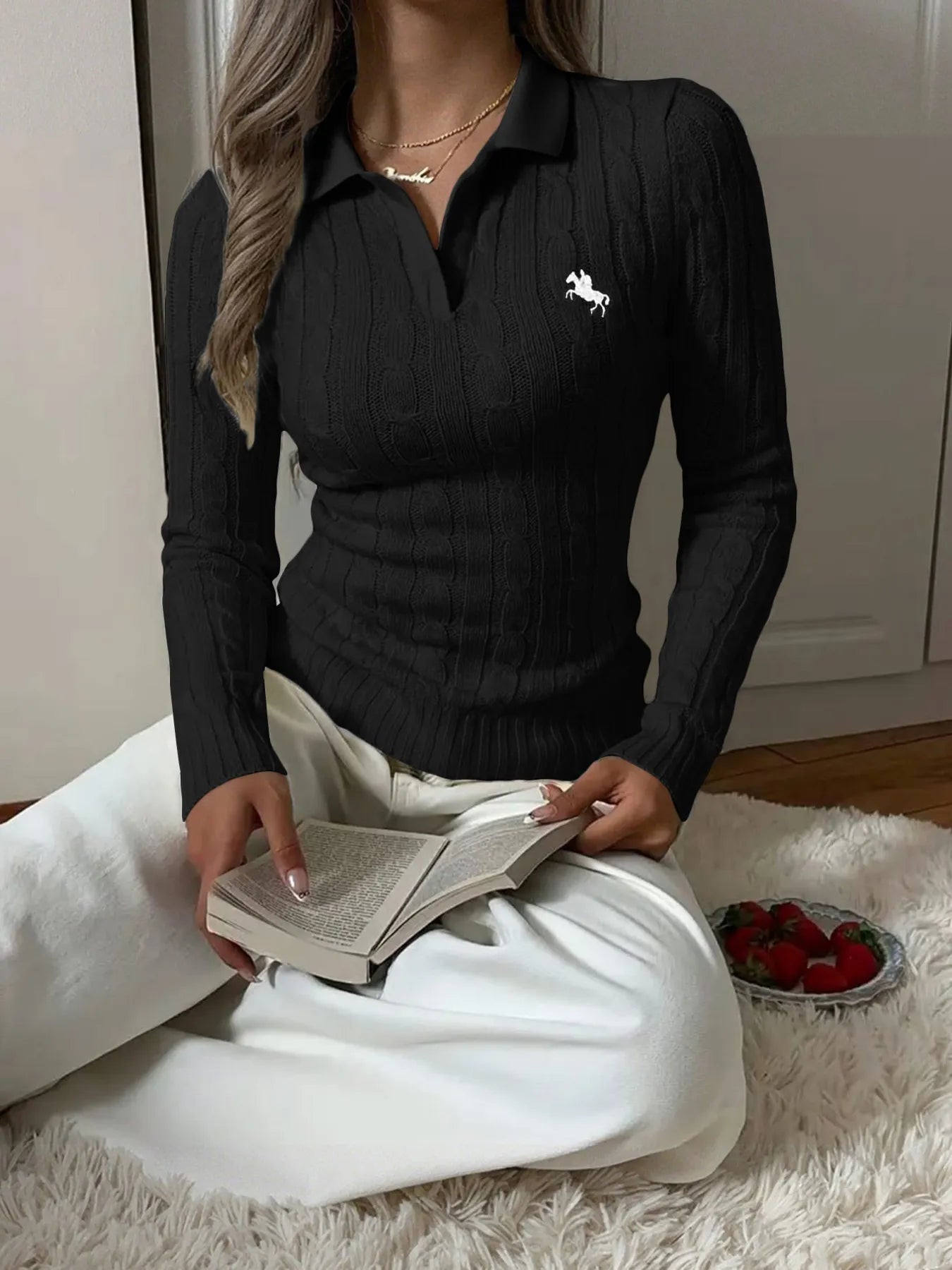 Black cable-knit long-sleeve sweater with buttoned collared neckline and horse logo on chest