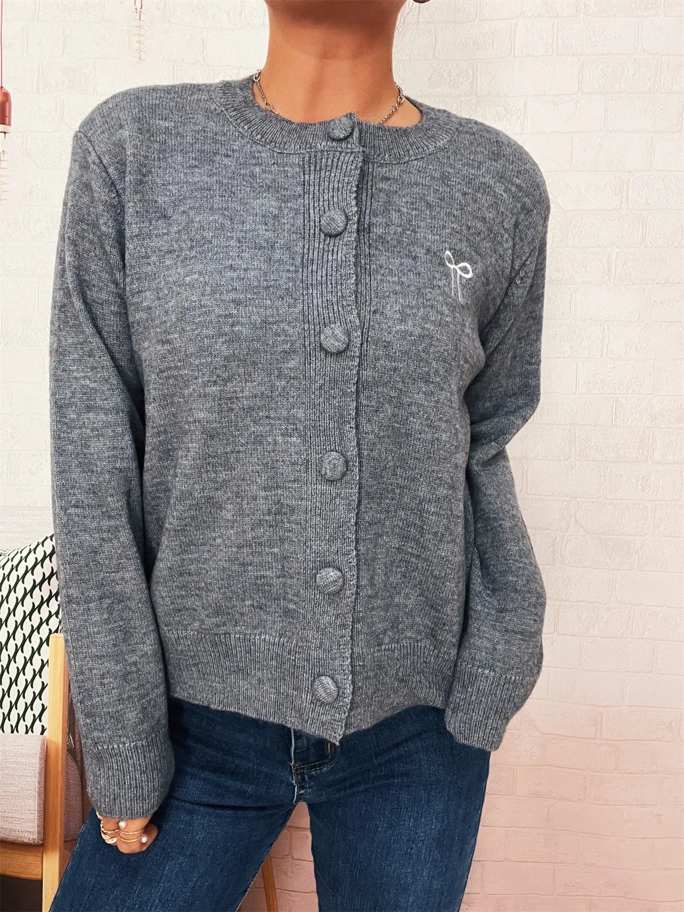 Medium gray button-up long sleeve cardigan with button front and knit fabric.