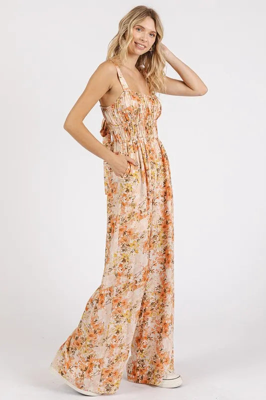 Peach floral sleeveless jumpsuit with gathered bust and flowing wide-leg legs