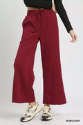 Burgundy cable knit wide-leg pants with drawstring waist and textured fabric