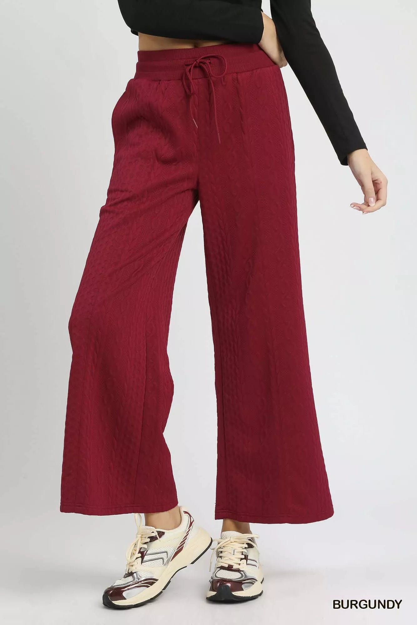 Burgundy cable knit wide-leg pants with drawstring waist and textured fabric
