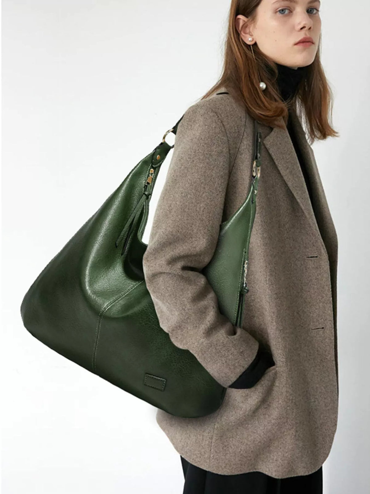 Large slouchy shoulder bag, green vegan leather, tassel accents and strap loops