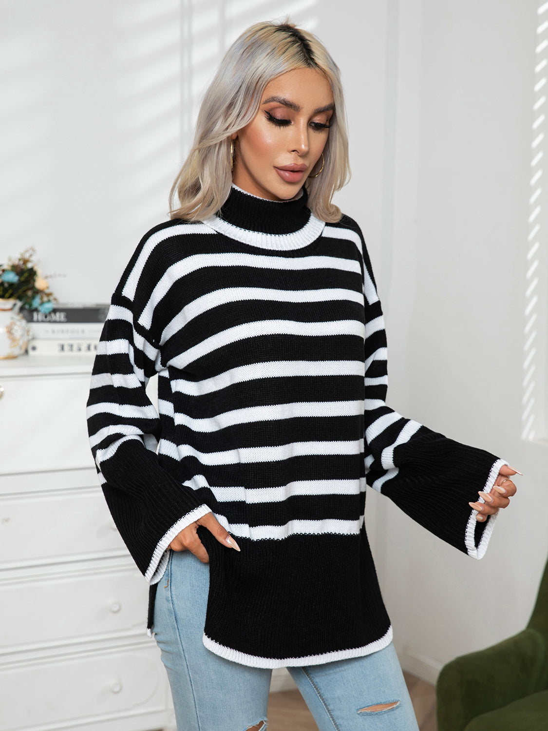 Black-and-white striped turtleneck sweater with drop shoulders and ribbed hem slit