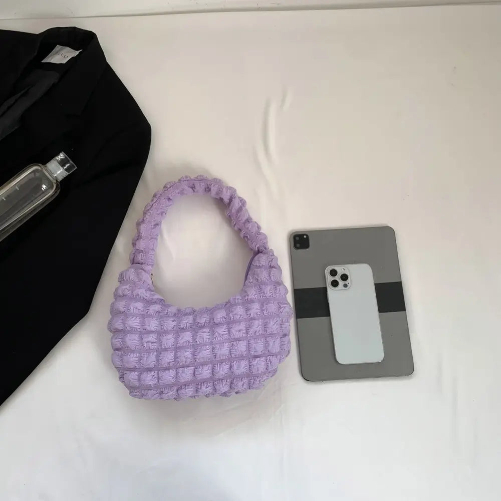 Lilac small textured handbag with openwork pattern and braided strap