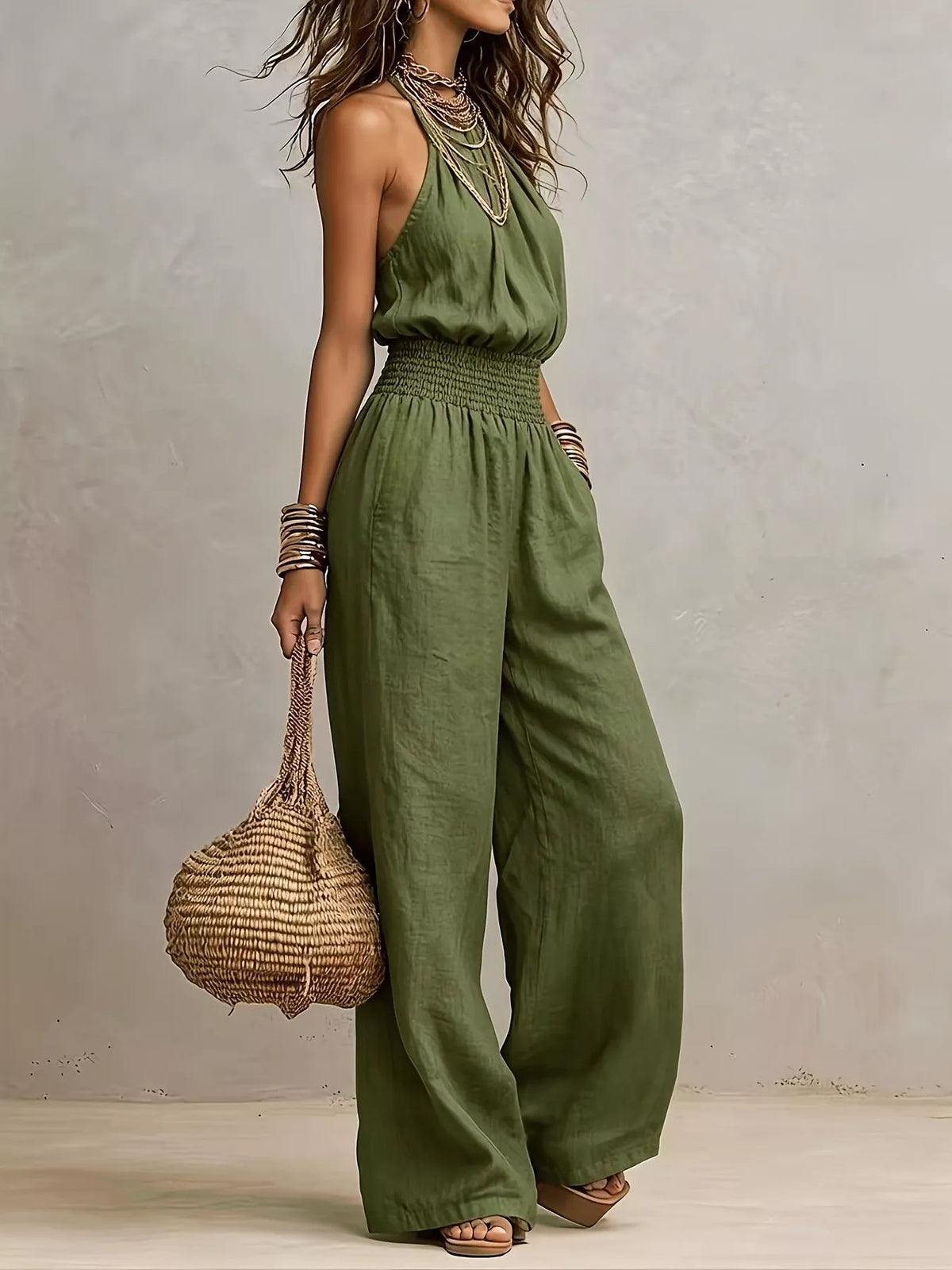 Army green smocked halter neck wide-leg jumpsuit with gathered waist and sleeveless fit.