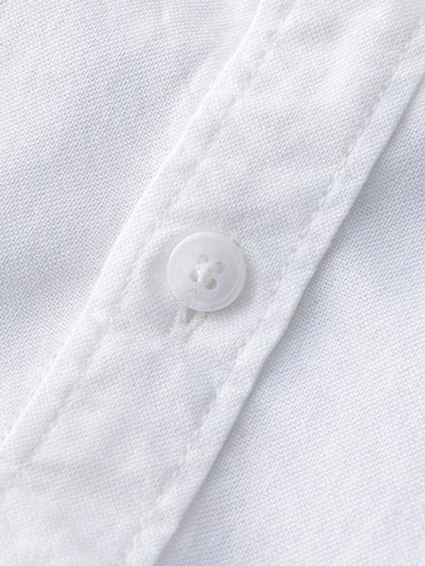 Plus size button-up long sleeve shirt sleeve button detail, white fabric with round buttons