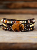 Triple-layer beaded bracelet with oval wood center and geometric square accents
