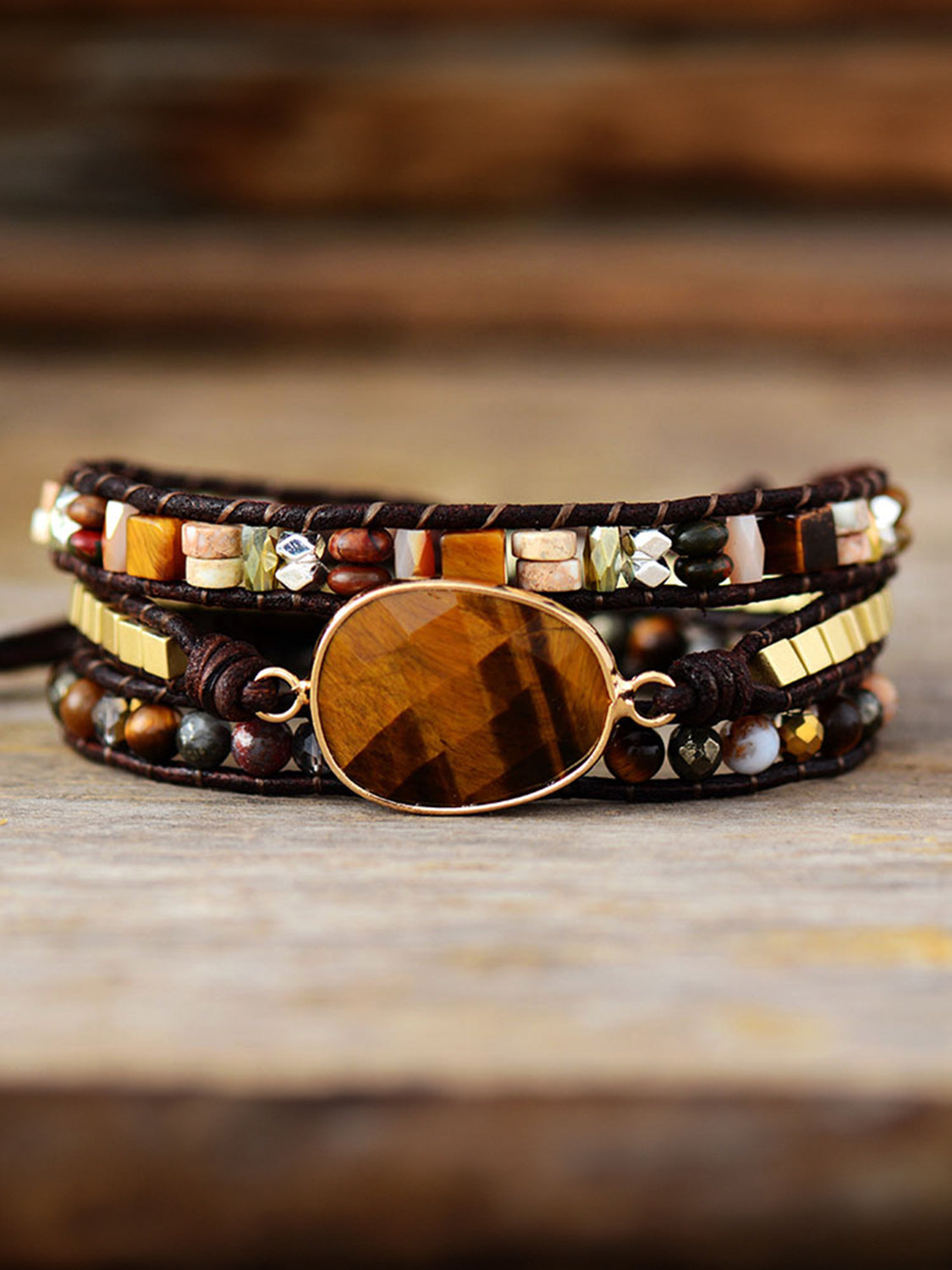Triple-layer beaded bracelet with oval wood center and geometric square accents