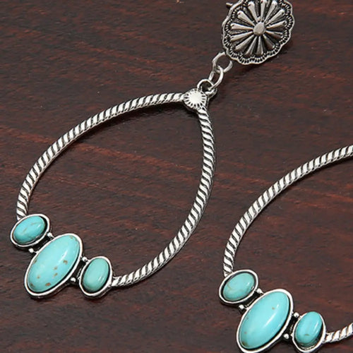 Silver teardrop hoop earrings with turquoise oval stone cluster and twisted rope loops