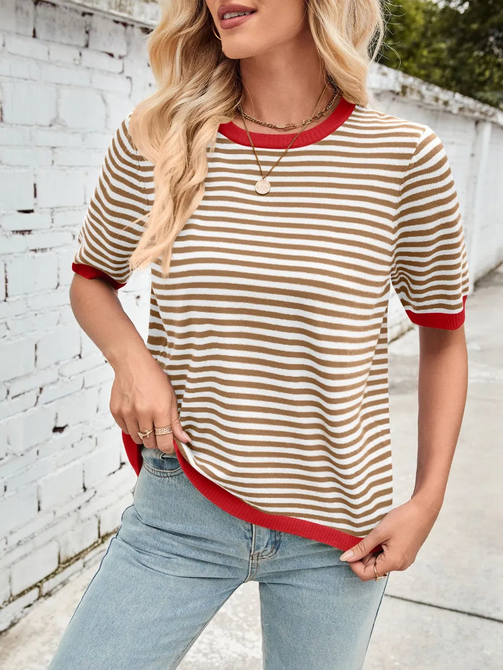 Black-and-white striped knit top with red contrast round neck and ribbed hem