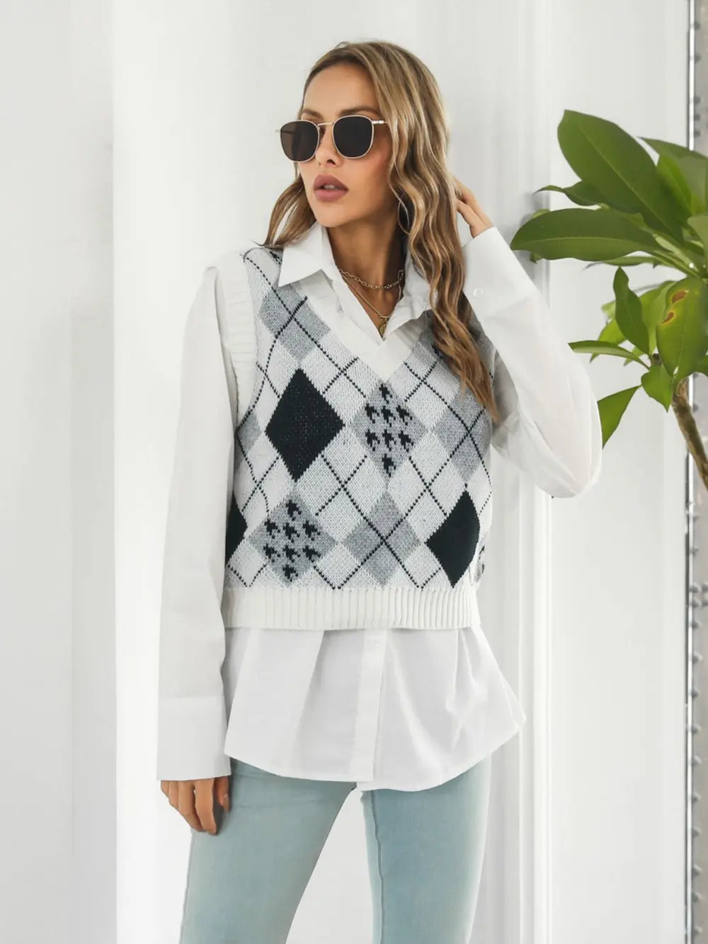 Front view V-neck plaid sweater vest with white base and black diamond checks, sleeveless knit