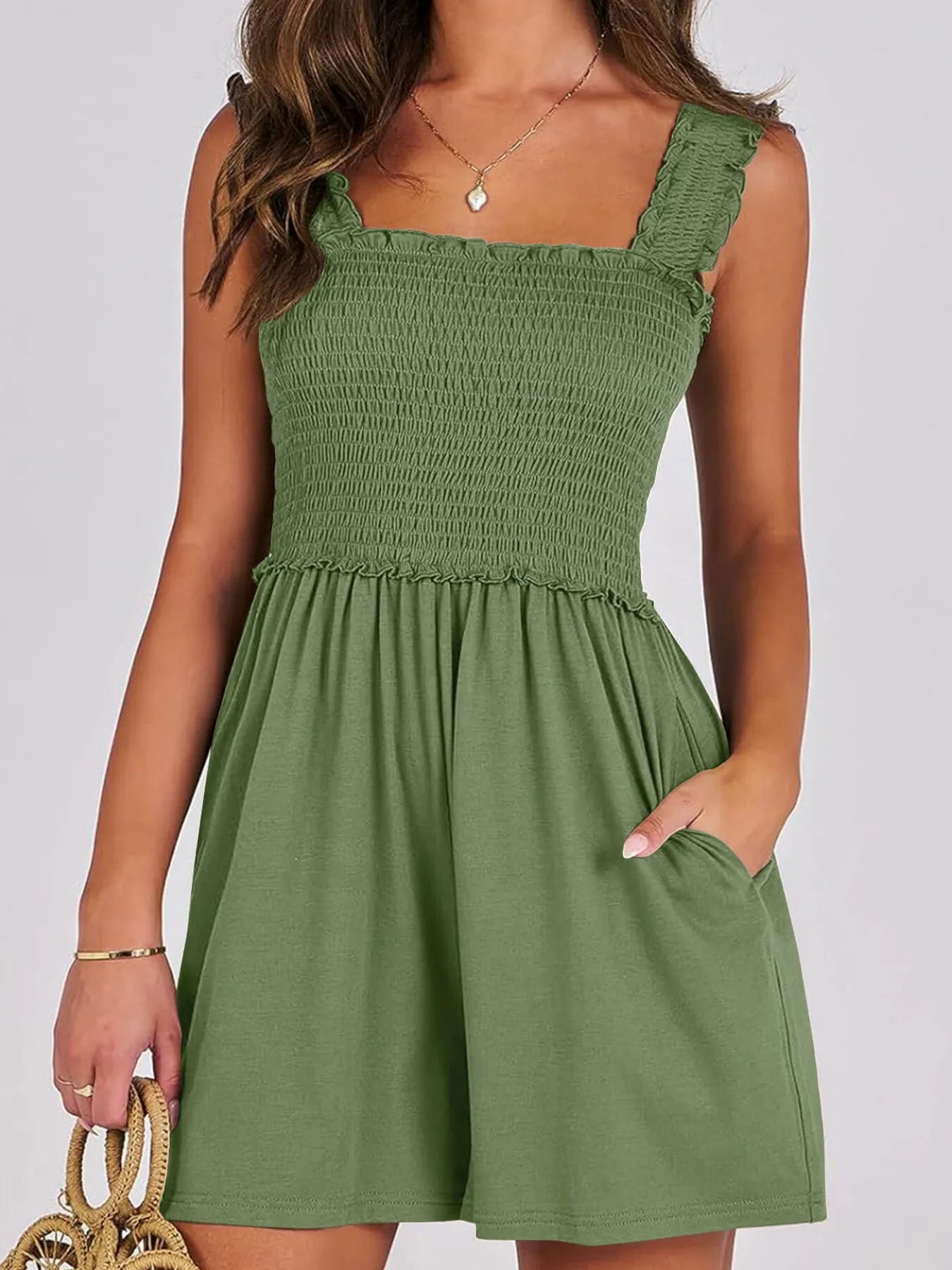Emerald green smocked square-neck summer romper with sleeveless ruffled straps and tiered skirt
