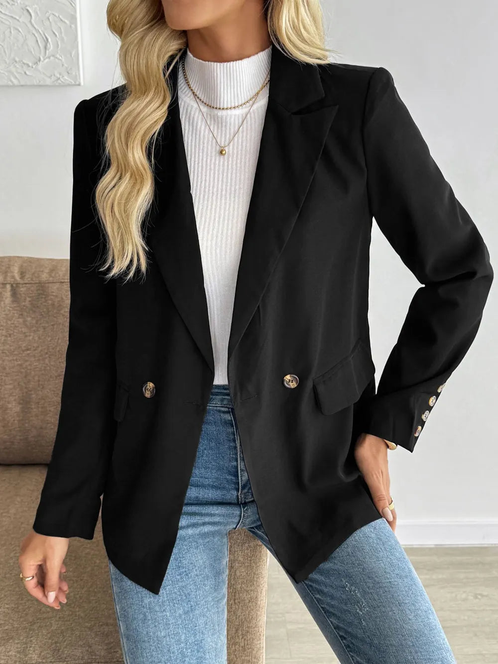 Black blazer with notch lapels and double-breasted style button placement