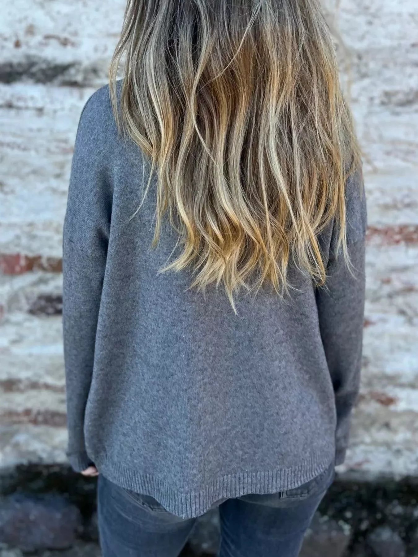 Gray back view turtleneck sweater with ribbed collar and long sleeves