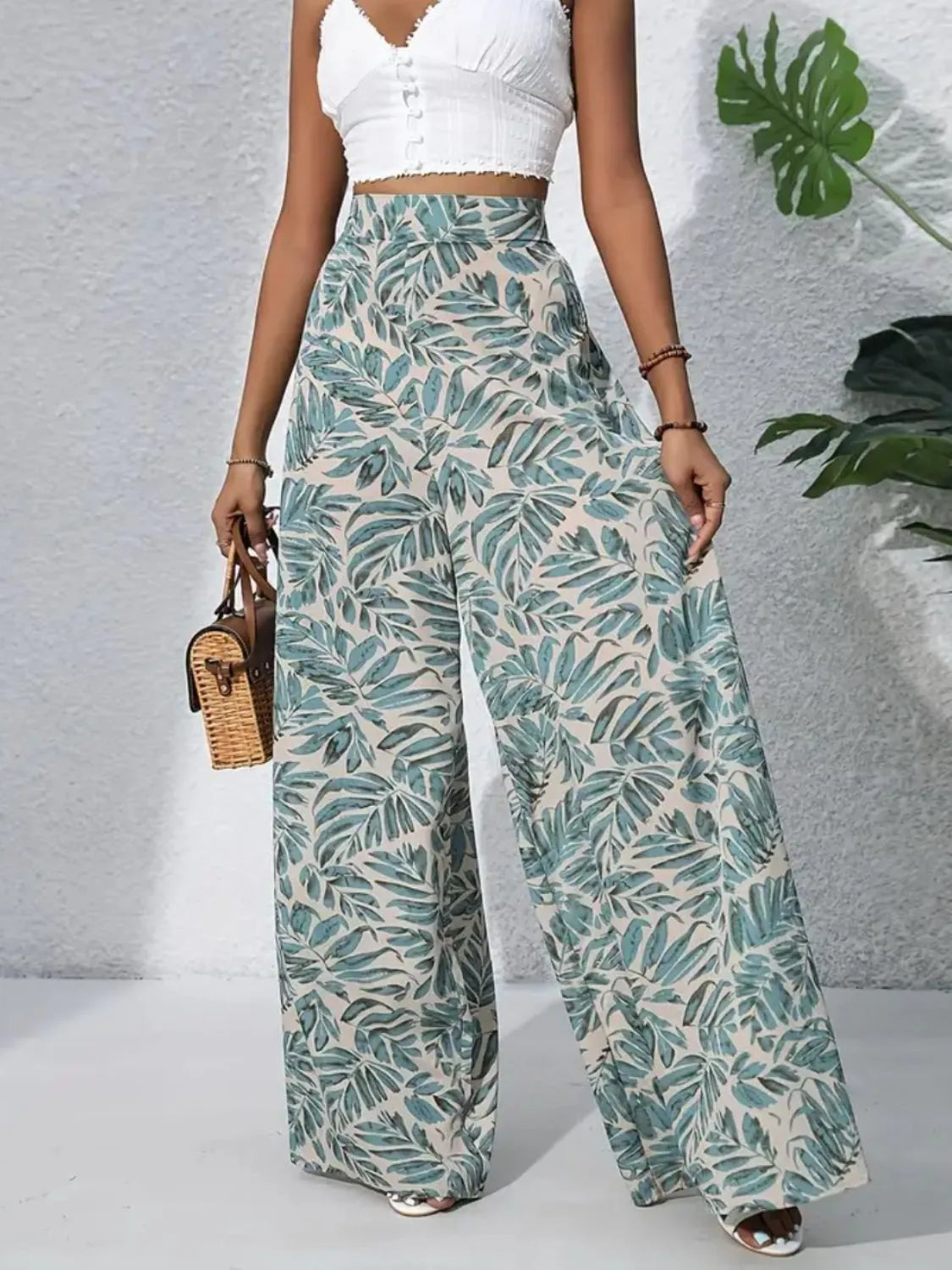 High-waist wide-leg pants in teal and cream with leafy print all over