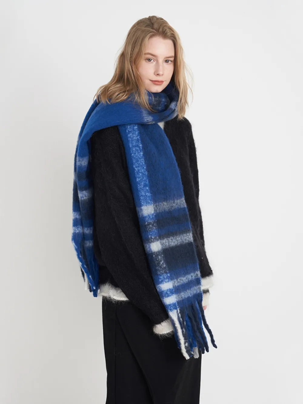 Plaid polyester scarf in blue and black with wide stripes and fringe.