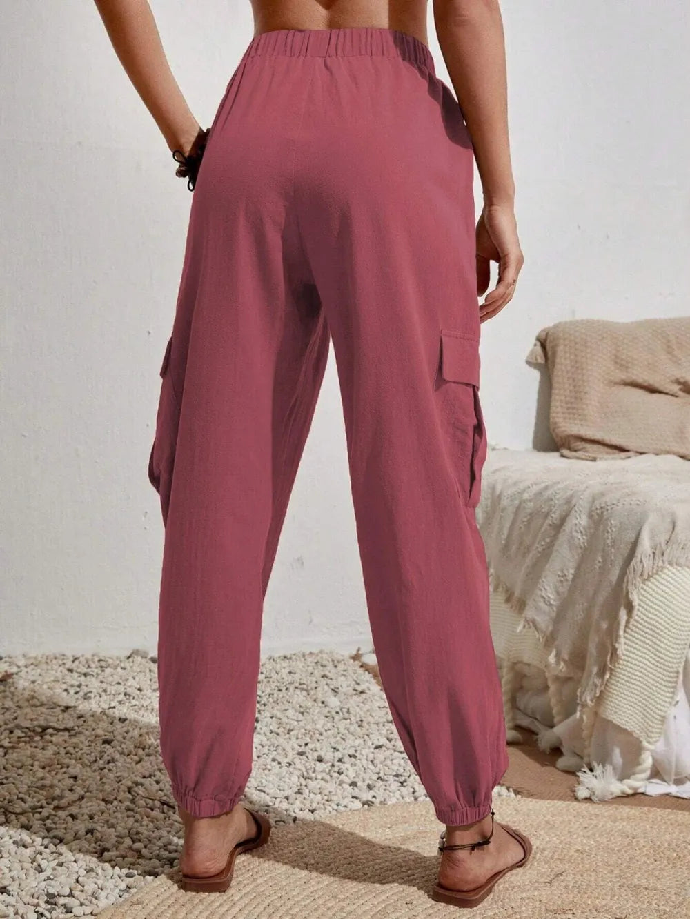 Dusty pink drawstring cargo joggers with cargo pockets and elastic ankles