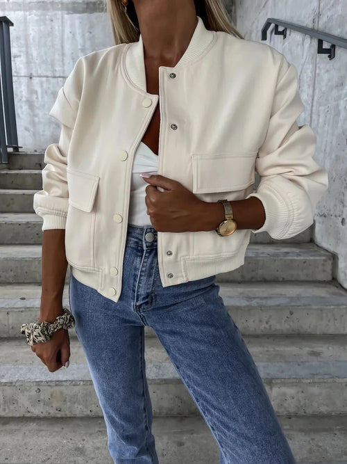Beige baseball-collar jacket with snap buttons, chest pocket, and ribbed cuffs.