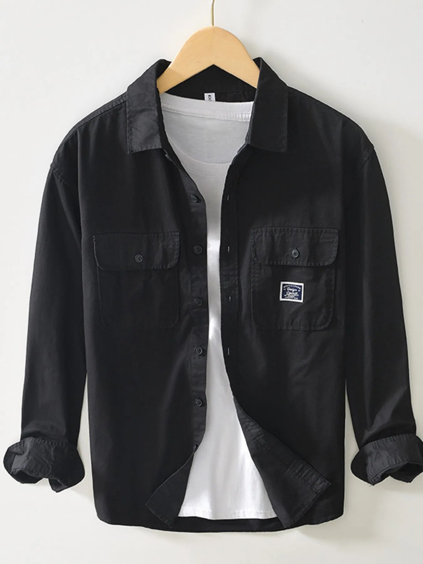Black button-up long sleeve shirt with chest pockets and button front